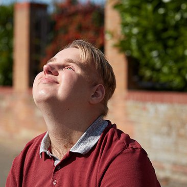 Alex sitting outside and looking at the sun
