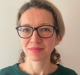 Bev Speight - she wears glasses and a green jumper