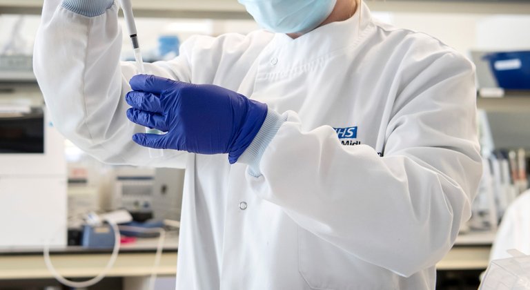 Image of scientist in a genomic testing lab