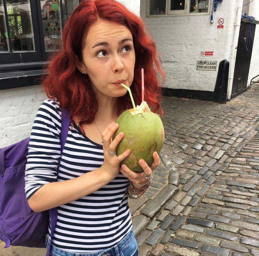 Sky drinking from a coconut through a straw
