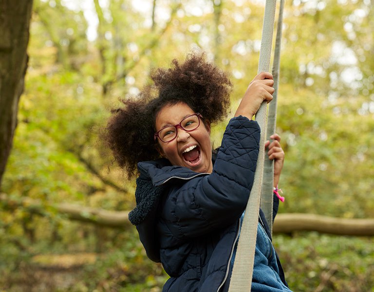 Zofeya swinging on a tree
