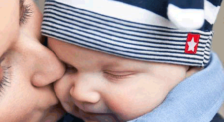 Mother kissing chid